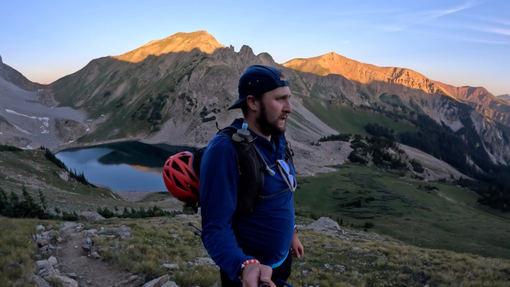 Hiker climbing toward Capitol Peak above Capitol Lake in Colorado