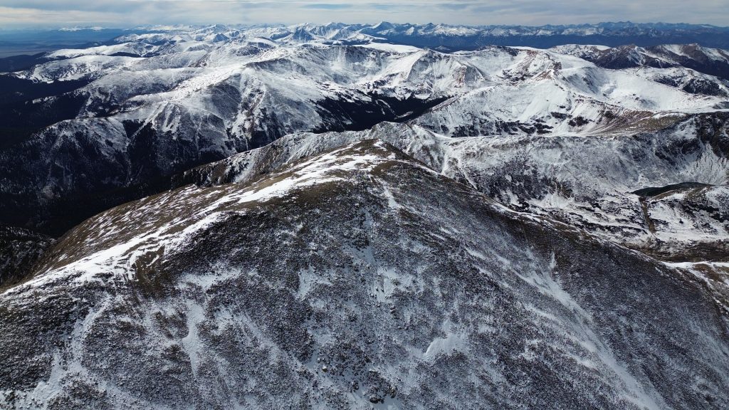 Drone view looking along the broad summit ridge of Square Top Mountain in Colorado.