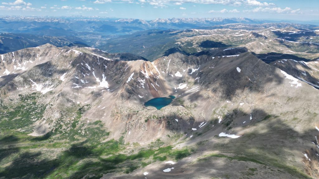 Aerial view of alpine lakes and rugged terrain below Grays Peak in Colorado.