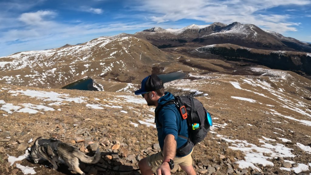 Hiker climbing the upper slopes of Square Top Mountain above Lower and Upper Square Top Lakes.