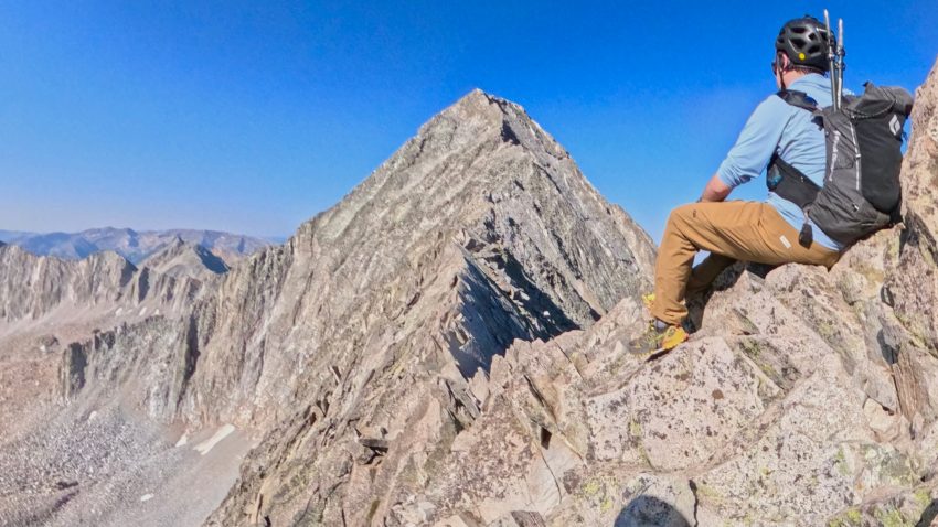 A hiker looks at the summit of Capitol Peak and its famous Knife Edge section.