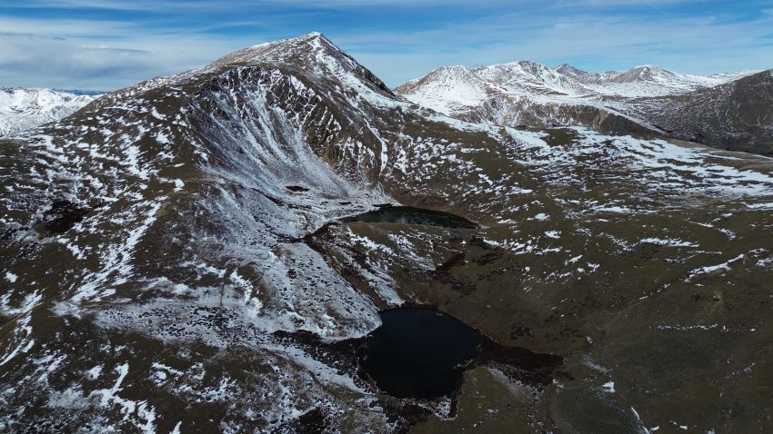 Drone view of Square Top Mountain rising above Upper and Lower Square Top Lakes in Colorado.