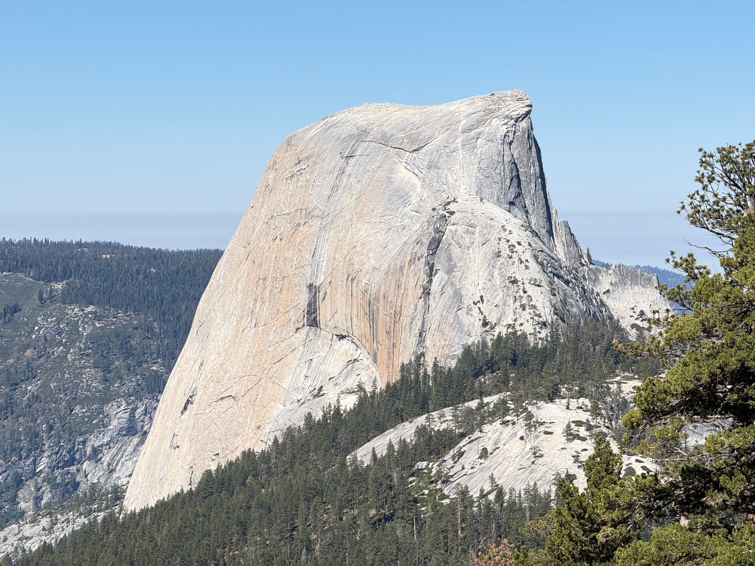 Close-up view of Half Dome's granite face as seen from the Clouds Rest hike in Yosemite National Park.